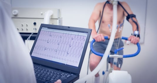 Man doing fitness test on exercise bike at the medical centre