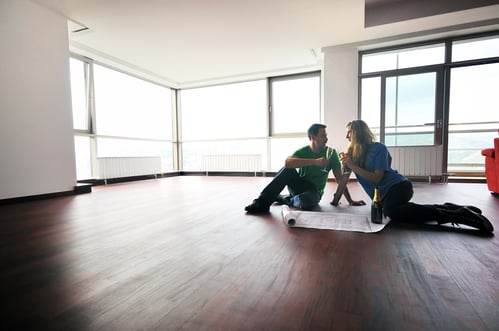 happy couple at big bright comfort apartment celebrate with glasses of champagne